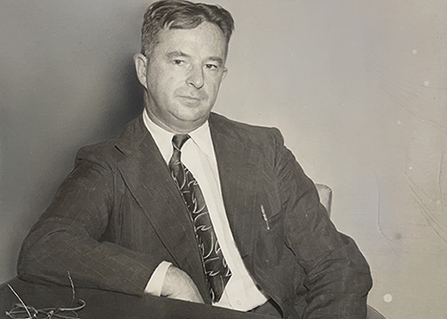Paul K. Guillow at desk